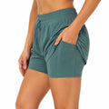 Short de sport femme taille S vert tissu extensible avec poches et taille réglable